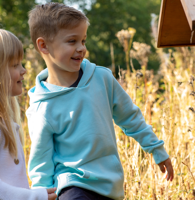 A young boy and girl smiling looking at nature