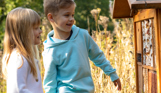 A young boy and girl smiling looking at nature