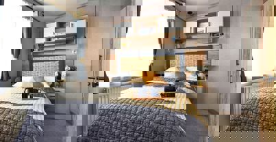 Comfy king size bed with separate wardrobe and shelving unit above the bed