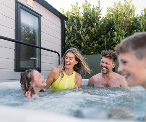 Family playing in their hot tub