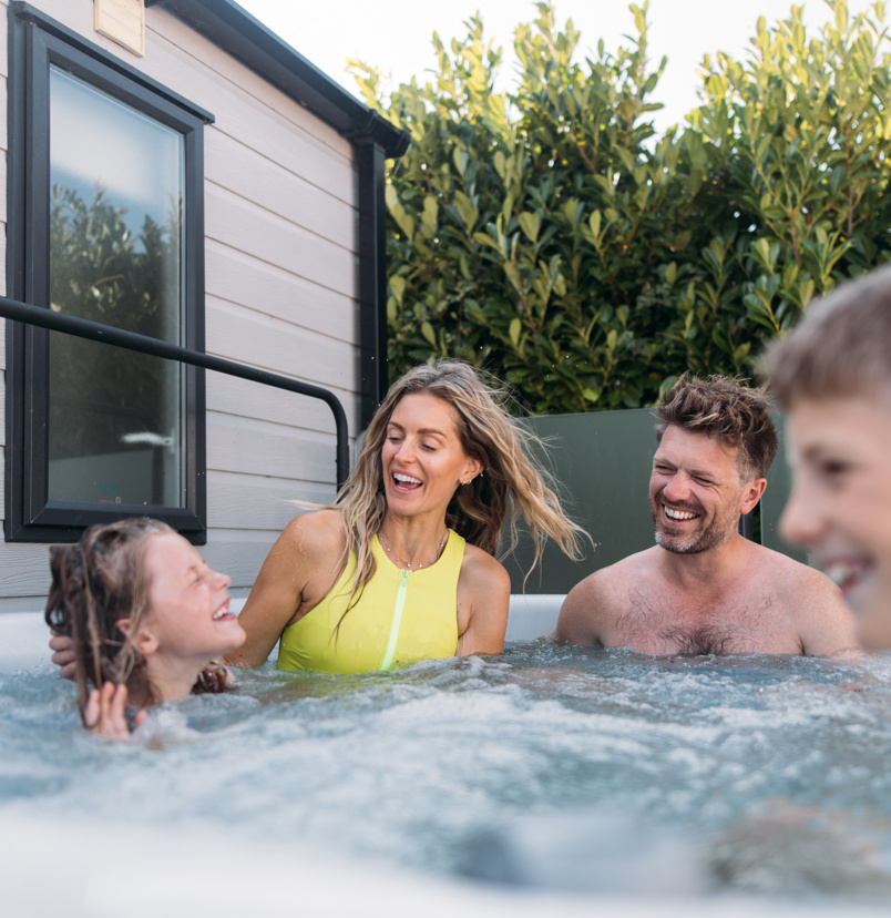 Family playing in their hot tub