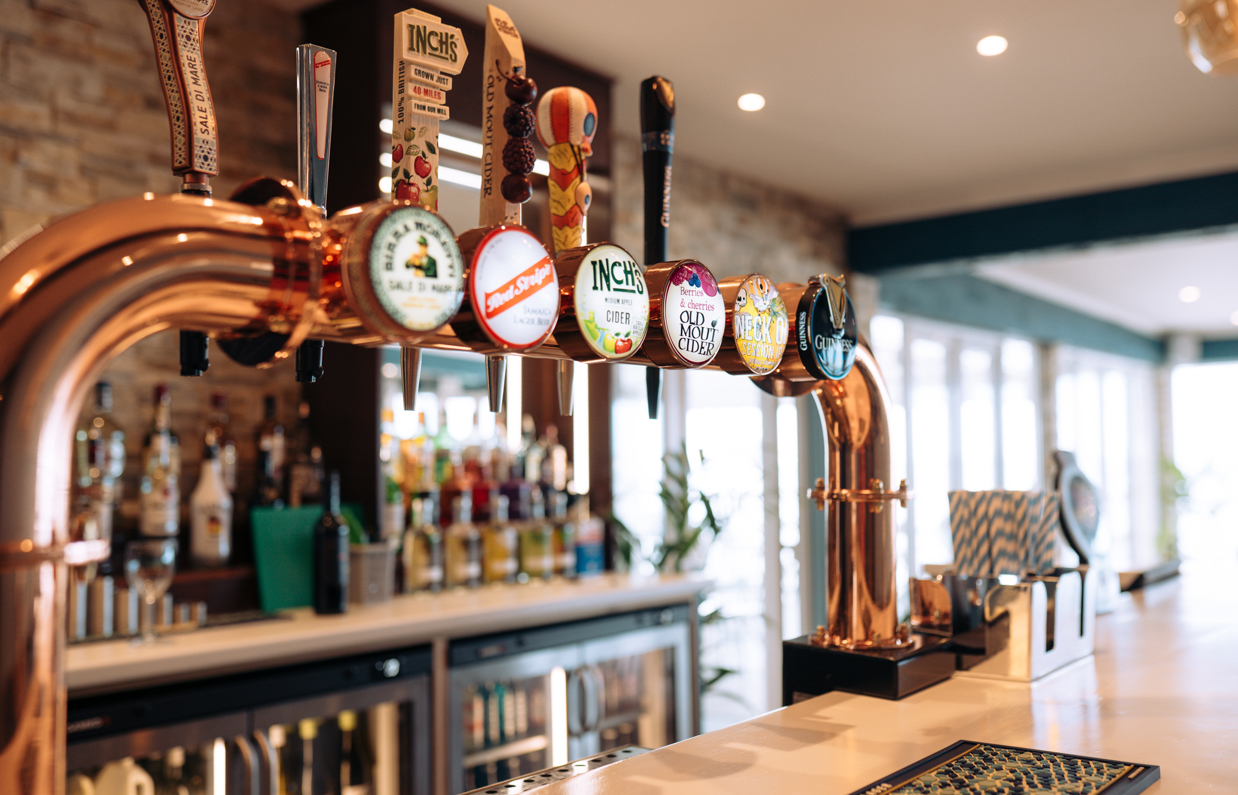 The bar at Drift Bar & Grill with various drinks on draught, spirits and fridges with wine and soft drinks