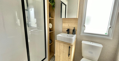 Internal of a caravan bathroom with shower sink and toilet
