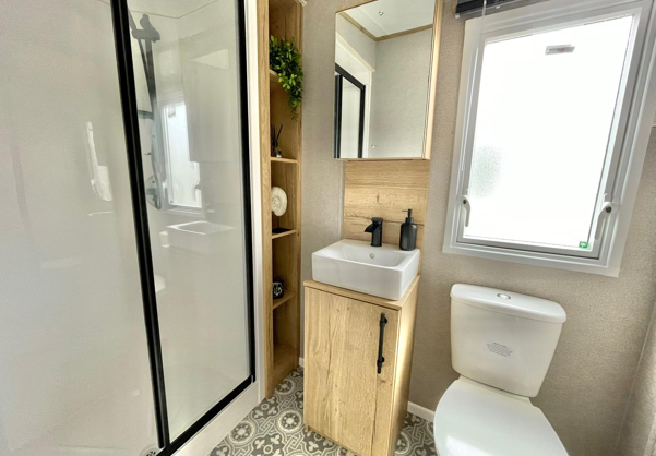 Internal of a caravan bathroom with shower sink and toilet