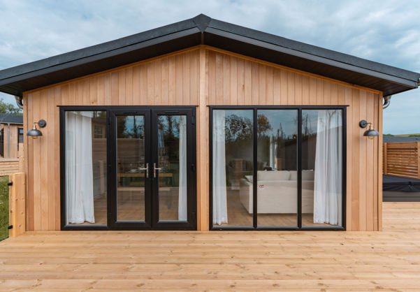 External of a luxury lodge on pitch with decking