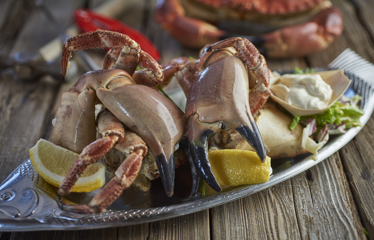 A seafood dish with crab claws and other garnish