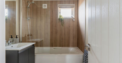 Internal of a luxury lodge bathroom with sink and shower over bath