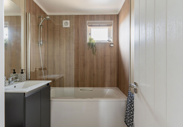 Internal of a luxury lodge bathroom with sink and shower over bath