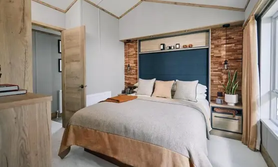 Master bedroom with natural stone colour them and faux brick wall with built-in storage