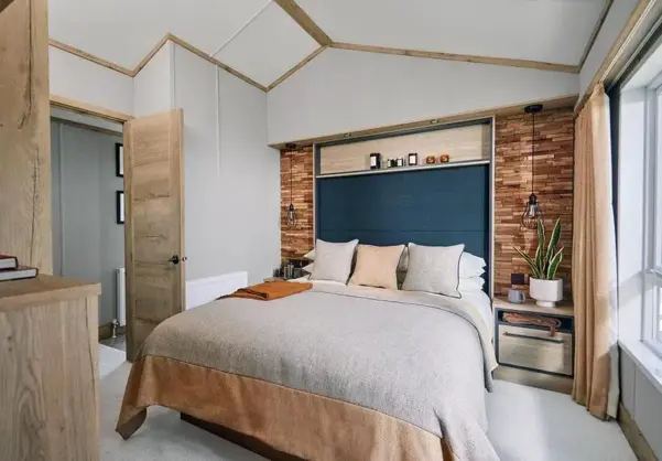 Master bedroom with natural stone colour them and faux brick wall with built-in storage