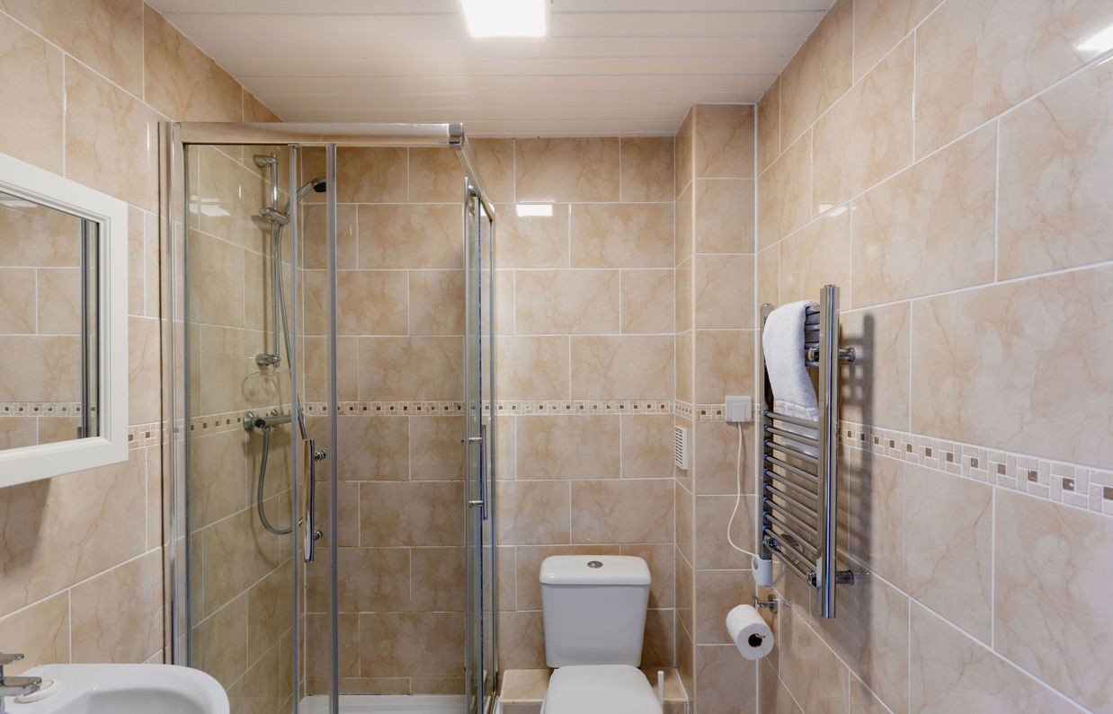 Internal of a cottage bathroom with shower, sink and toilet
