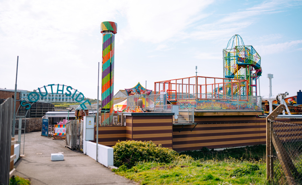 The entrance to an outdoor funfair called Southside Funfair with a range of rides and other children's entertainment