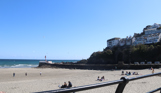 The view out towards the sea and Banjo Pier from Looe Beach on a sunny, blue sky day