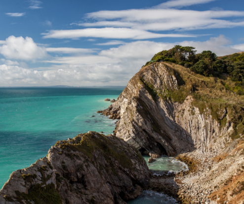 A section of the Jurassic Coast with rocky cliffs and blue sea