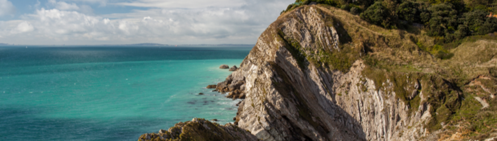 A section of the Jurassic Coast with rocky cliffs and blue sea