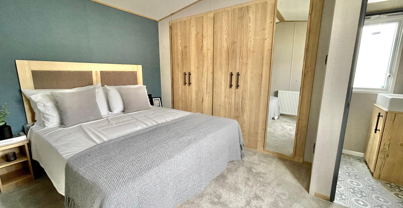 Internal of a caravan master bedroom with storage and ensuite