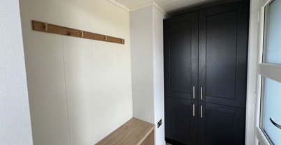 Entrance with storage cupboard, bench and coat hooks