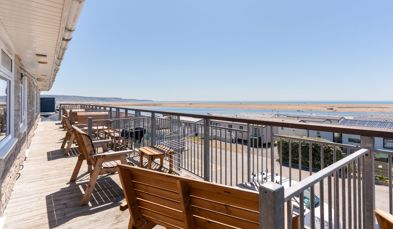 Views of Chesil Beach and the Jurassic Coast from the balcony of Chesil Beach apartments with outdoor furniture