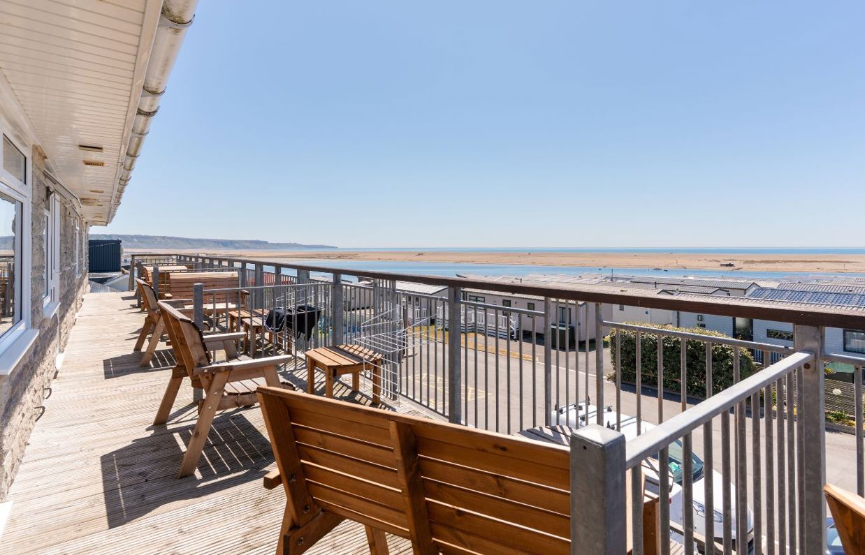Views of Chesil Beach and the Jurassic Coast from the balcony of Chesil Beach apartments with outdoor furniture