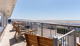 Views of Chesil Beach and the Jurassic Coast from the balcony of Chesil Beach apartments with outdoor furniture