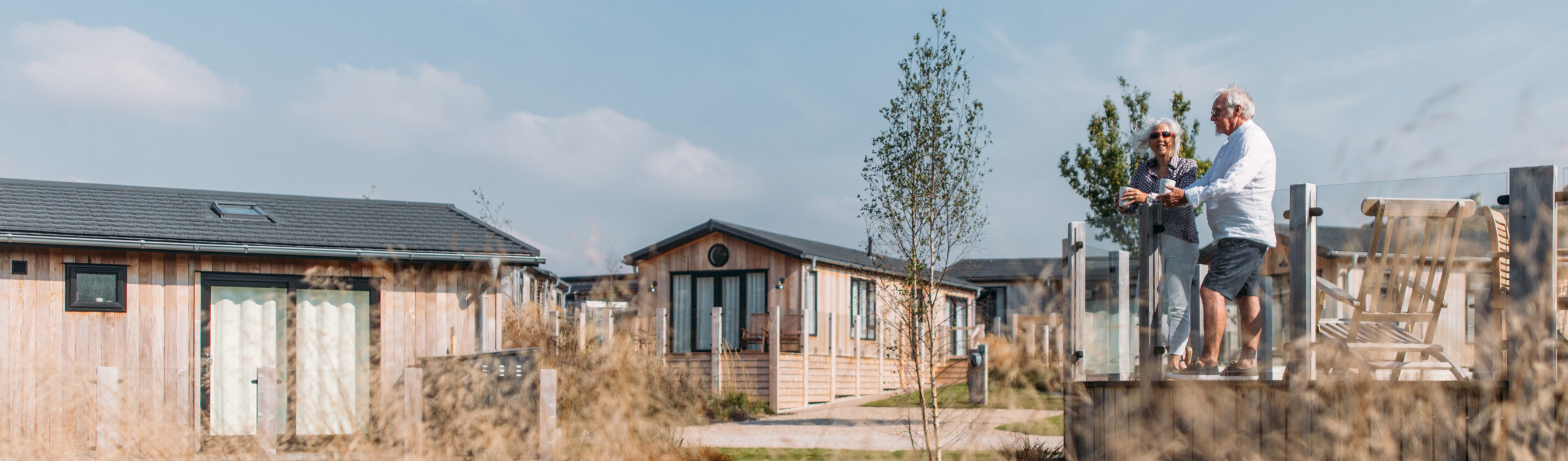 Elder couple relaxing on deck of Stables Lodge