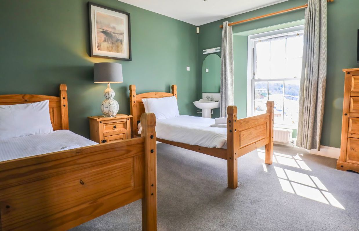 Internal of a manor house twin bedroom with sink