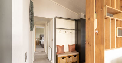 Entrance hall of holiday lodge showing bench seating and coat hooks