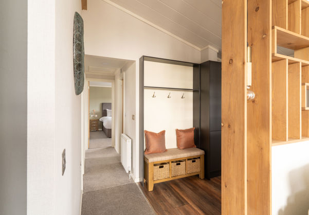 Entrance hall of holiday lodge showing bench seating and coat hooks