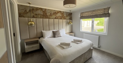 Master bedroom with large bed and modern luxury styling