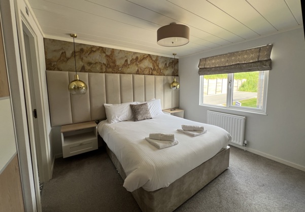 Master bedroom with large bed and modern luxury styling