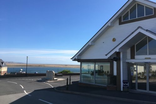 The reception at Chesil Beach containing a small shop for essentials with seaviews