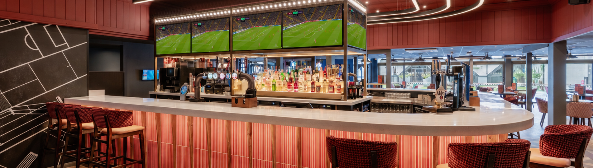The bar area at the arena sports bar with football on the TVs