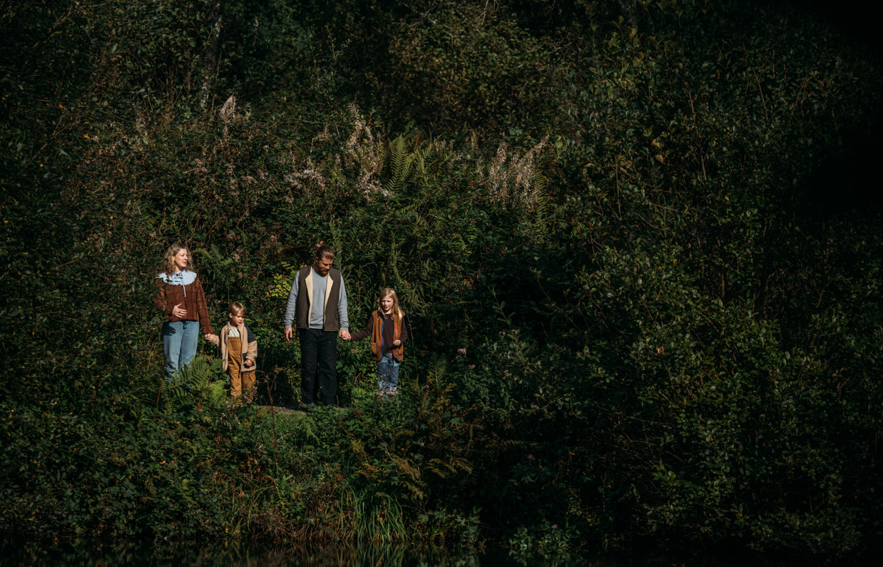 A family of four among woodland on a nature trail at Tregoad Holiday Park