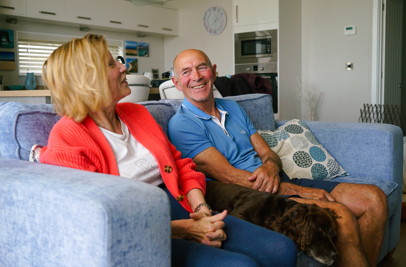Osmington Owners on sofa with dog and husband looking at wife