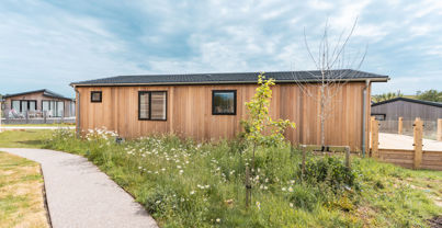 External of a luxury lodge on pitch with decking