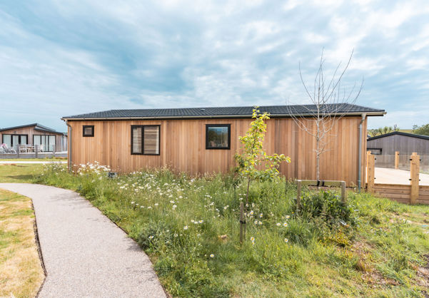 External of a luxury lodge on pitch with decking