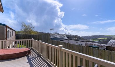 External of a caravan with decking and a hot tub