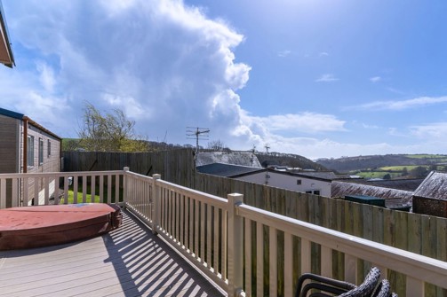 External of a caravan with decking and a hot tub