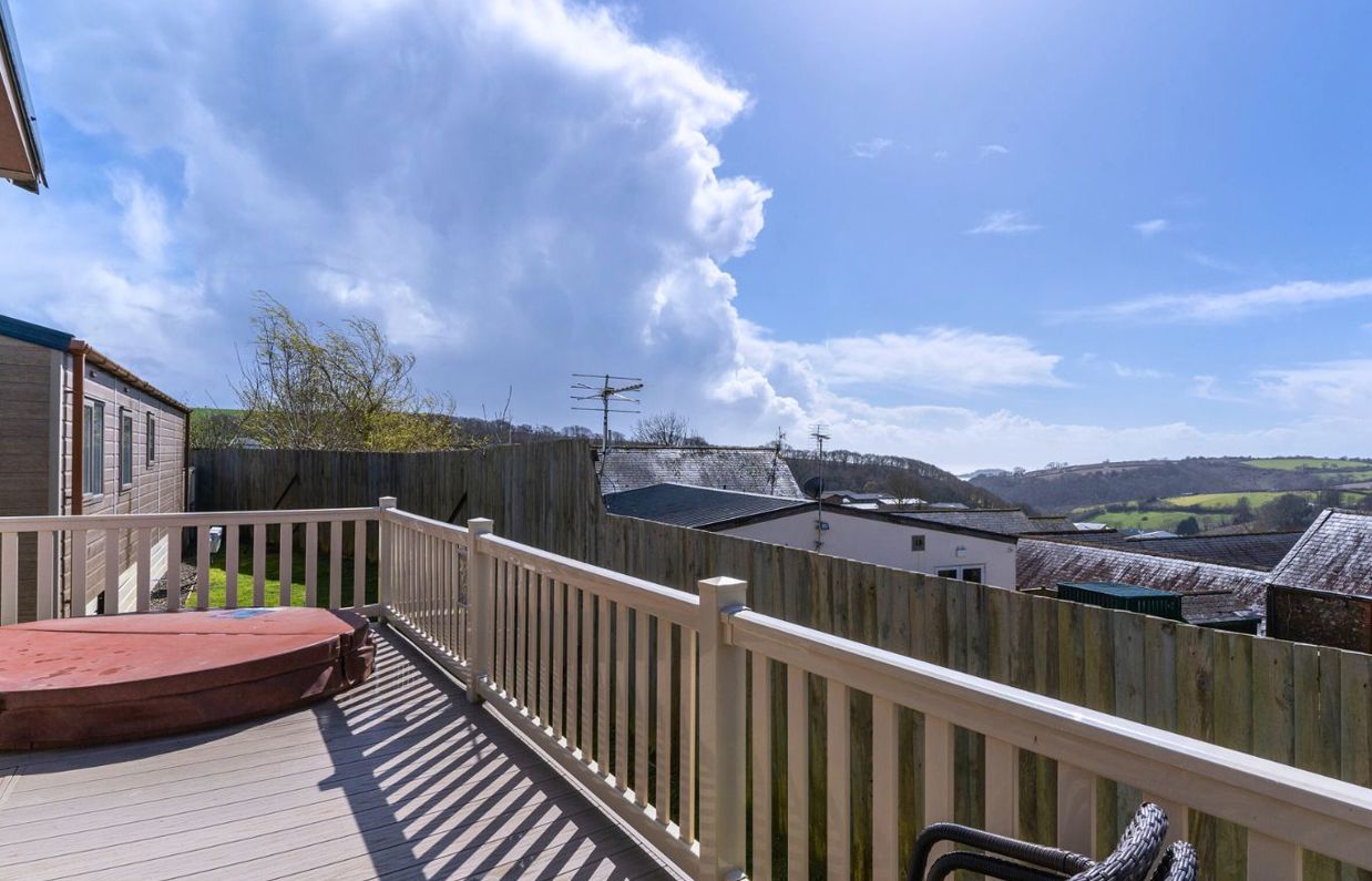 External of a caravan with decking and a hot tub