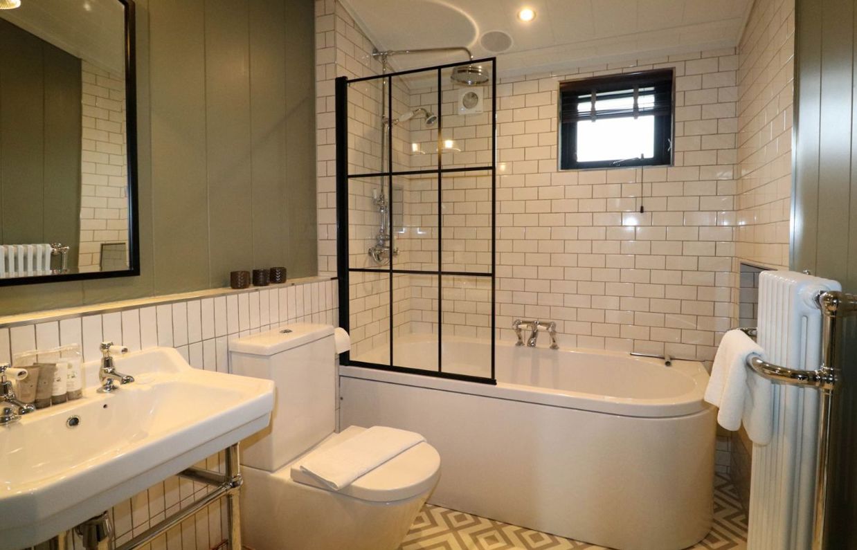 Internal of a luxury lodge bathroom with shower over bath toilet and sink