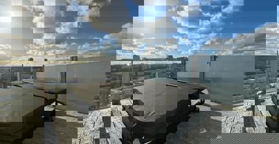 Large hot tub on decking overlooking valley