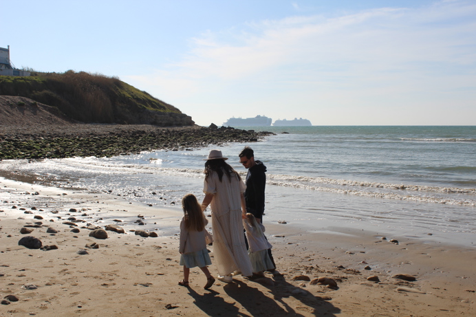 Family walking on beach in spring