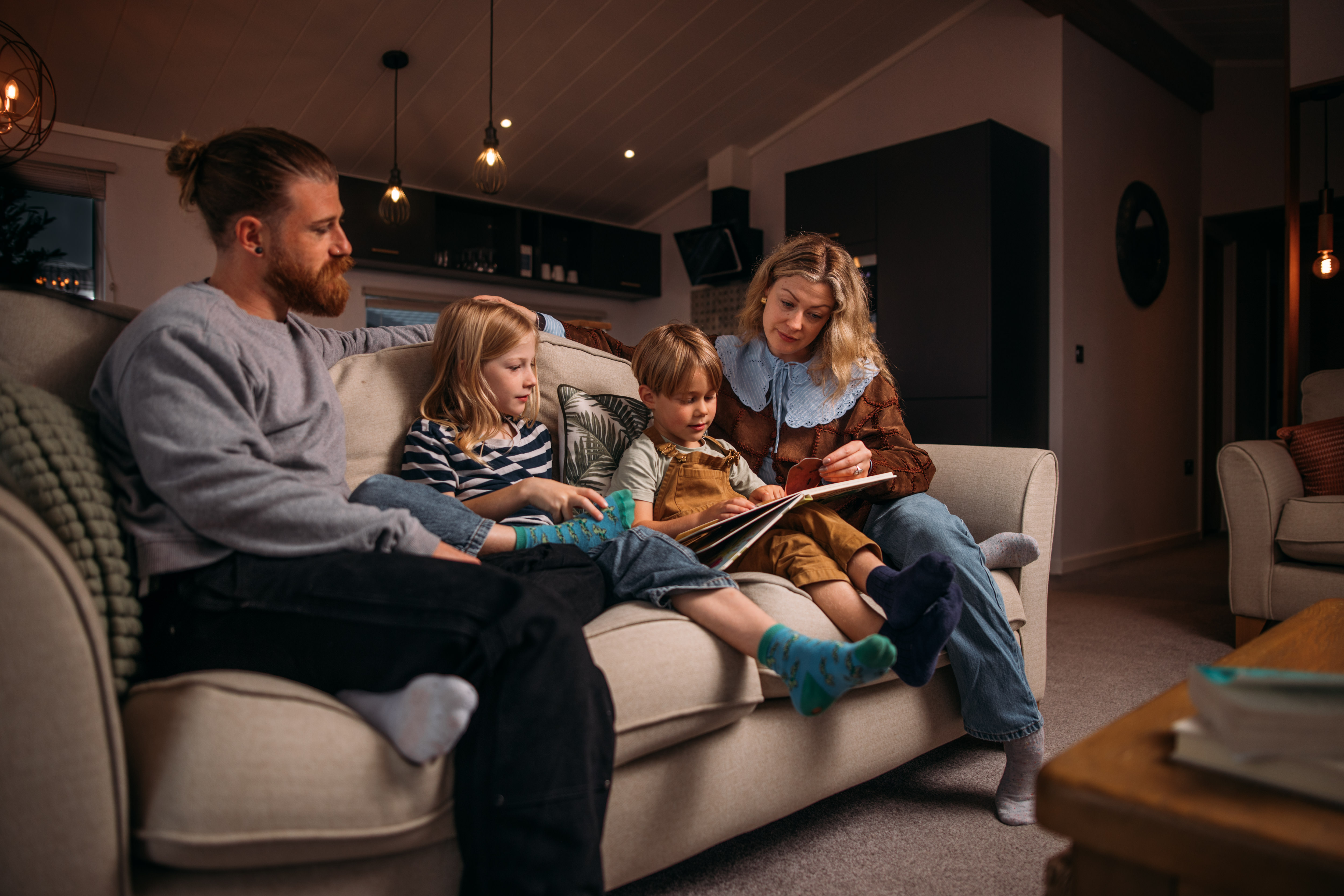 Family enjoying bedtime reading time at holiday home in Tregoad