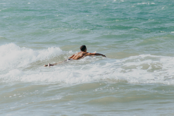 A man body boarding in the sea