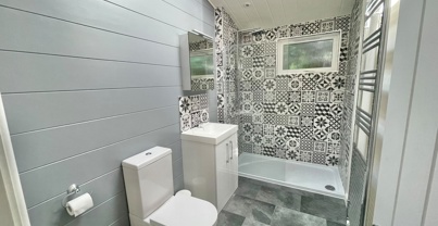 Internal of a luxury lodge bathroom with walk-in shower, sink and toilet