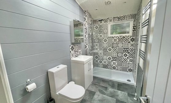 Internal of a luxury lodge bathroom with walk-in shower, sink and toilet