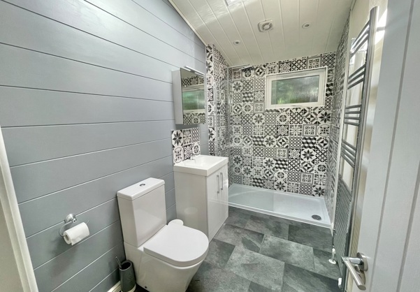Internal of a luxury lodge bathroom with walk-in shower, sink and toilet