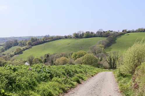A nature path along a countryside valley with rolling hills