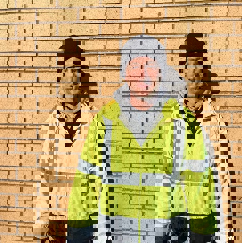 A man wearing high-vis clothing smiling 