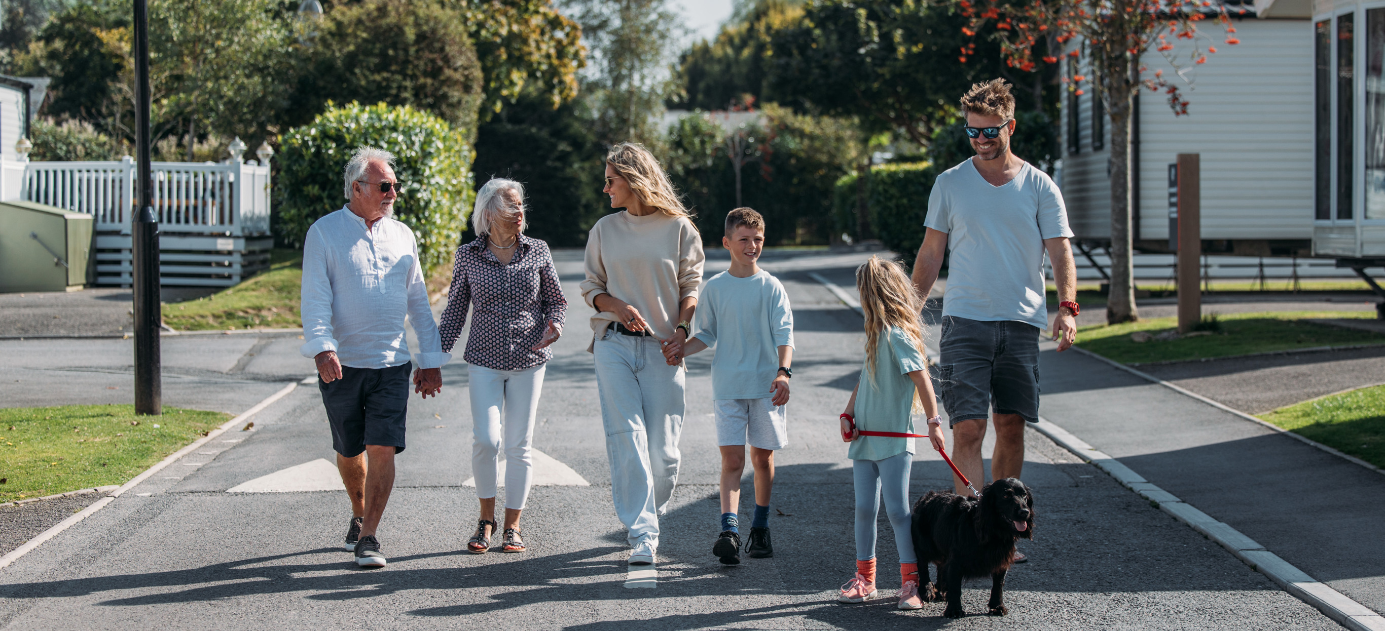Multi generational family walking through park